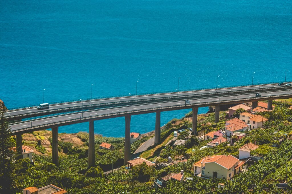 aerial photo of concrete bridge near body of water