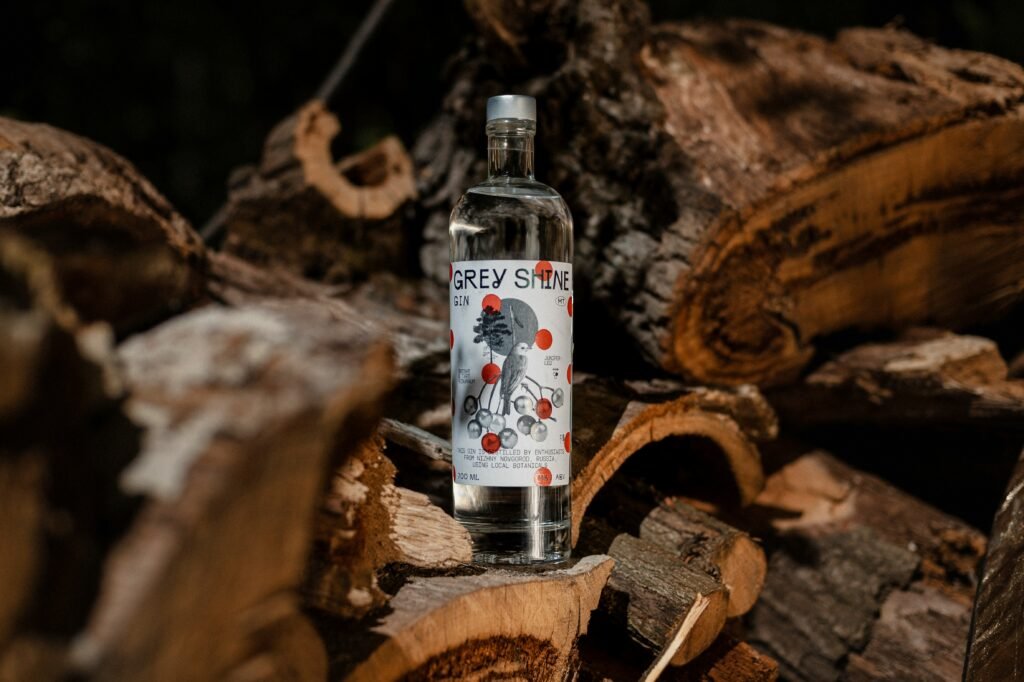 a bottle of vodka sitting on top of a pile of wood